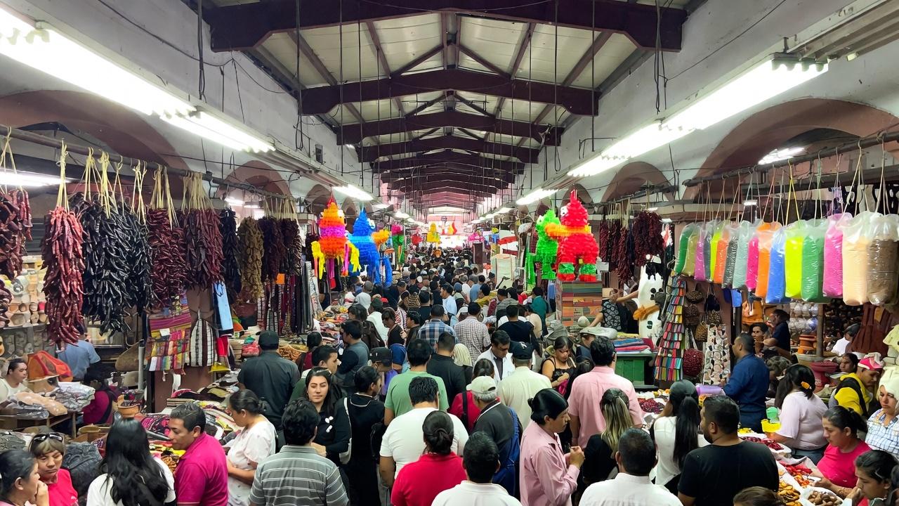 Busy Mexican market stalls in Guadalajara where pickpocket awareness is important